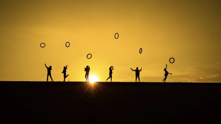 Children Play With Tire On The Sanddunes