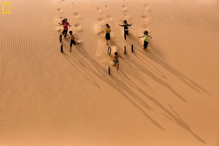 Children play on sand dunes, Binh Thuan, NG003